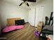 Bright bedroom featuring wood-look flooring, ceiling fan, and a closet at 3806 N 80Th Dr, Phoenix, AZ 85033