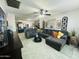 Open-concept living room featuring a large sectional sofa and view into the kitchen at 3806 N 80Th Dr, Phoenix, AZ 85033