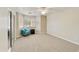 Bright bedroom featuring a large closet, a cozy chair by the window, and neutral carpeting throughout at 4202 E Broadway Rd # 40, Mesa, AZ 85206