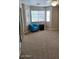 Spacious bedroom featuring a comfy chair, ample natural light, and carpet flooring at 4202 E Broadway Rd # 40, Mesa, AZ 85206