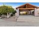 The community center has an inviting entrance with a wood covering, steps and beautiful landscaping at 4202 E Broadway Rd # 40, Mesa, AZ 85206