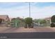 The community gate features decorative tree detailing, beautiful brick pillars and landscaping at 4202 E Broadway Rd # 40, Mesa, AZ 85206