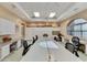 Large craft room with tables, chairs, cabinets, and natural light from an arched window at 4202 E Broadway Rd # 40, Mesa, AZ 85206