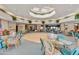 Inviting dining hall with tables and chairs surrounding a wooden dance floor, bathed in natural light at 4202 E Broadway Rd # 40, Mesa, AZ 85206