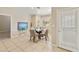 Bright dining room with tile floors, a glass table, seating for four, and a door to the patio at 4202 E Broadway Rd # 40, Mesa, AZ 85206