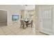 Charming dining area featuring tile floors, a glass table with four chairs, and plenty of natural light at 4202 E Broadway Rd # 40, Mesa, AZ 85206