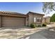 Charming home's exterior showing a tile roof, two-car garage, and well-maintained landscaping at 4202 E Broadway Rd # 40, Mesa, AZ 85206