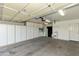 Spacious garage with ample storage cabinets, utility sink and door to the house at 4202 E Broadway Rd # 40, Mesa, AZ 85206