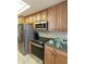 Modern kitchen featuring stainless steel appliances, wood cabinets, and stylish countertops at 4202 E Broadway Rd # 40, Mesa, AZ 85206