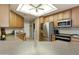 Bright kitchen with stainless steel appliances, light wood cabinetry and an island with countertop seating at 4202 E Broadway Rd # 40, Mesa, AZ 85206