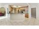 Modern kitchen with stainless steel appliances, wooden cabinets, and an island counter overlooking a nearby living space at 4202 E Broadway Rd # 40, Mesa, AZ 85206