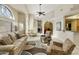 Bright living room featuring soaring ceilings, tile floors, large windows, and an open floor plan layout at 4202 E Broadway Rd # 40, Mesa, AZ 85206