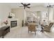 Bright living room with tile floors, fireplace, ceiling fans, and lots of natural light at 4202 E Broadway Rd # 40, Mesa, AZ 85206