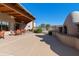 Spacious patio with an impressive outdoor fireplace and comfortable seating under an attractive wood canopy at 4202 E Broadway Rd # 40, Mesa, AZ 85206
