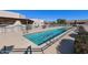 Inviting outdoor swimming pool with metal handrails and a concrete deck surrounded by greenery at 4202 E Broadway Rd # 40, Mesa, AZ 85206