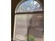 Arched window adorned with geometric stained glass, offering a unique aesthetic touch at 4202 E Broadway Rd # 40, Mesa, AZ 85206