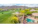 Aerial view of the backyard including a pool and patio and the adjacent community golf course at 42102 N Long Cove Way, Phoenix, AZ 85086