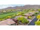 Real estate showcases beautiful homes along a lush golf course with mountain views in the background at 42102 N Long Cove Way, Phoenix, AZ 85086