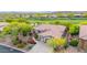 Aerial view of a home surrounded by lush landscaping and a well-manicured lawn at 42102 N Long Cove Way, Phoenix, AZ 85086