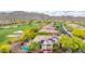 Home featuring solar panels, a pool, an outdoor seating area, and a golf course nearby at 42102 N Long Cove Way, Phoenix, AZ 85086