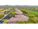Aerial view of the neighborhood showcasing the community landscape including mature trees and desert vegetation at 42102 N Long Cove Way, Phoenix, AZ 85086