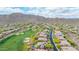 Aerial view showcases the neighborhood with mature trees, beautiful landscaping, and mountain views at 42102 N Long Cove Way, Phoenix, AZ 85086