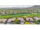 Expansive aerial view of the neighborhood highlighting the surrounding golf course and beautiful mountain views at 42102 N Long Cove Way, Phoenix, AZ 85086