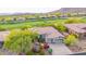 Beautiful home with solar panels, a manicured front yard, and golf course views in a gated community at 42102 N Long Cove Way, Phoenix, AZ 85086
