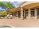 Spacious covered back patio with lounge chairs, dining area, and desert landscaping at 42102 N Long Cove Way, Phoenix, AZ 85086