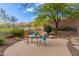 Relaxing back patio seating area with desert landscaping and mountain views beyond the fence at 42102 N Long Cove Way, Phoenix, AZ 85086