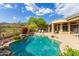 Backyard pool featuring rock detail, adjacent to outdoor seating, and lush landscaping at 42102 N Long Cove Way, Phoenix, AZ 85086
