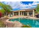 Backyard with pool featuring rock detail, landscaping, outdoor seating and patio space at 42102 N Long Cove Way, Phoenix, AZ 85086