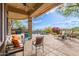 Outdoor seating beside the beautiful backyard pool surrounded by lush landscaping and a covered patio at 42102 N Long Cove Way, Phoenix, AZ 85086