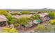Aerial view of the beautiful backyard, including a pool, patio, and lush desert landscaping in a gated community at 42102 N Long Cove Way, Phoenix, AZ 85086