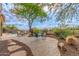 Wide backyard with desert landscaping, mountain views, and a sitting area under a shady tree at 42102 N Long Cove Way, Phoenix, AZ 85086