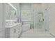 Modern bathroom featuring a soaking tub, glass shower, marble accents, and plantation shutters at 42102 N Long Cove Way, Phoenix, AZ 85086