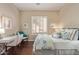 Relaxing bedroom featuring wood floors, a writing desk, and plantation shutters at 42102 N Long Cove Way, Phoenix, AZ 85086