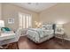 Bright bedroom features wood floors, a writing desk, and plantation shutters at 42102 N Long Cove Way, Phoenix, AZ 85086