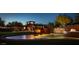 Exterior dusk view of the Anthem Country Club with illuminated water feature at 42102 N Long Cove Way, Phoenix, AZ 85086