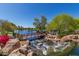 Scenic community park view featuring a bridge, water features, and lush greenery at 42102 N Long Cove Way, Phoenix, AZ 85086