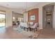 Elegant dining room with a modern chandelier, glass table, and access to the living room at 42102 N Long Cove Way, Phoenix, AZ 85086