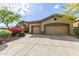 Lovely home featuring a three-car garage, a tile roof, and colorful desert landscaping at 42102 N Long Cove Way, Phoenix, AZ 85086