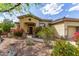 Charming home exterior featuring a gated entrance, a tile roof, and desert landscaping at 42102 N Long Cove Way, Phoenix, AZ 85086