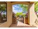 Charming front gate with stone pillars leading to a beautifully landscaped yard at 42102 N Long Cove Way, Phoenix, AZ 85086