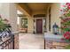 Inviting covered front porch with decorative stone pillars and a charming sitting area at 42102 N Long Cove Way, Phoenix, AZ 85086