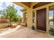 Inviting covered front porch with decorative stone pillars and a charming sitting area at 42102 N Long Cove Way, Phoenix, AZ 85086