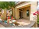 Inviting covered front porch with decorative stone pillars and a charming sitting area at 42102 N Long Cove Way, Phoenix, AZ 85086