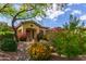 Charming home showcasing lush landscaping, colorful flowers, and inviting curb appeal at 42102 N Long Cove Way, Phoenix, AZ 85086