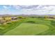 Aerial view of a meticulously manicured golf course with a blue flag marking the green in a beautiful golf community at 42102 N Long Cove Way, Phoenix, AZ 85086