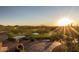 Scenic view of the golf course at sunset with mountains in the distance at 42102 N Long Cove Way, Phoenix, AZ 85086